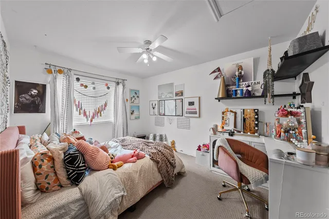 a bedroom with a bed a dresser and next to a window