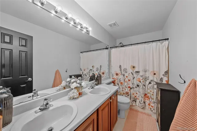 a kitchen with stainless steel appliances granite countertop a sink dishwasher a stove and a refrigerator with wooden floor