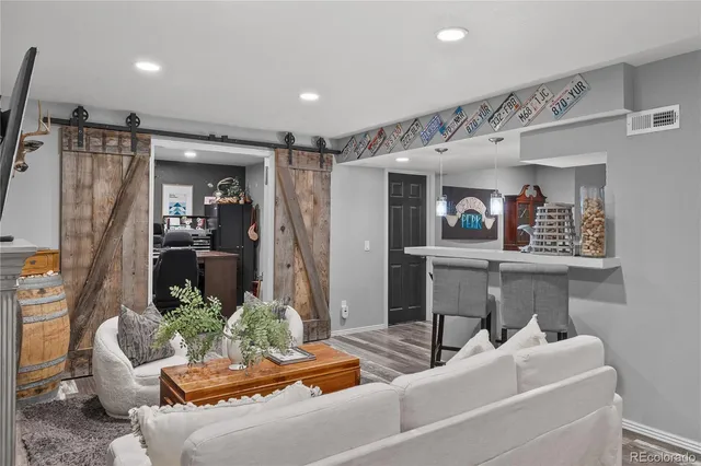 a bathroom with a granite countertop sink a toilet a mirror and shower
