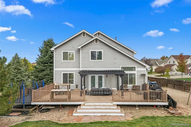 an aerial view of residential houses with outdoor space and trees
