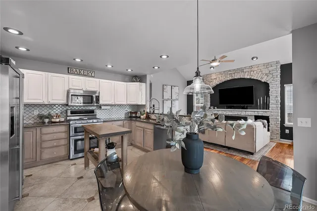 a kitchen with stainless steel appliances kitchen island granite countertop a stove and cabinets
