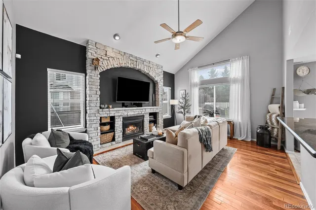 a living room with fireplace furniture and a flat screen tv