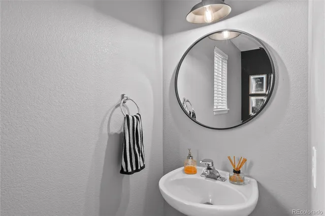 a view of staircase with lots of frames on wall and wooden floor