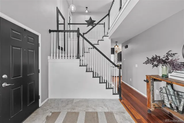 a view of a hallway with bedroom and wooden floor