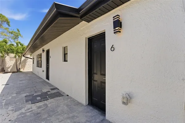 a view of front door and a yard