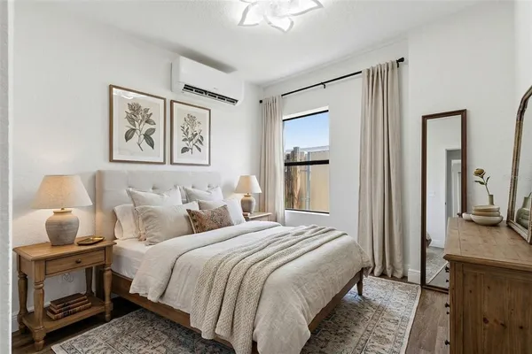 a bedroom with bed and a chandelier
