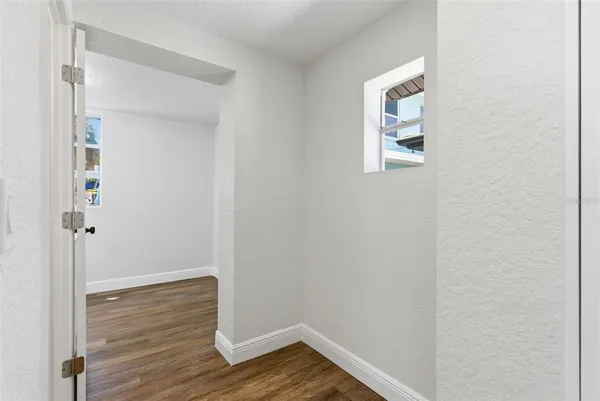 a view of a room with wooden floor