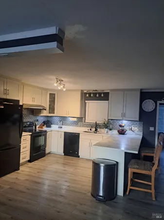 a kitchen with a sink stainless steel appliances and cabinets