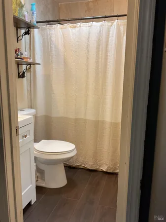 a bathroom with a toilet and a shower