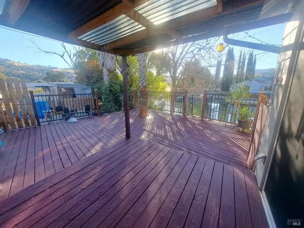 a porch with wooden floors in front of it