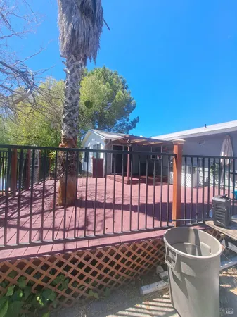 a house with yard and a trees in the background