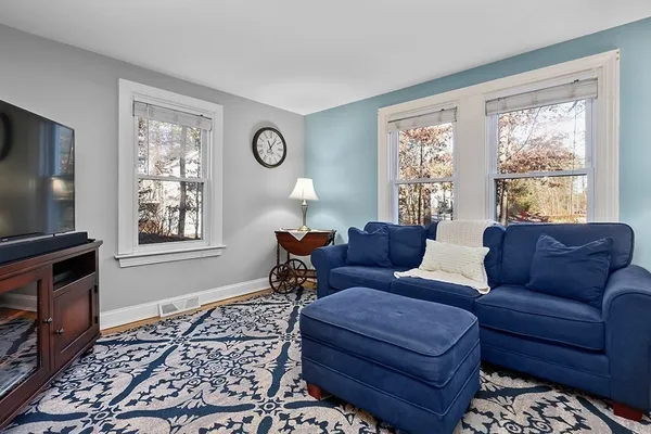 a living room with furniture and a rug