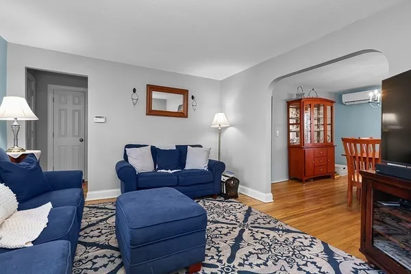 a living room with furniture fireplace and a window