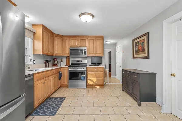 a kitchen with stainless steel appliances granite countertop a refrigerator and a stove top oven