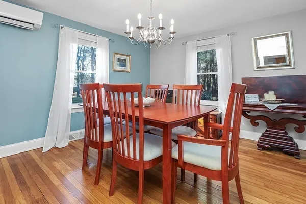 a view of a dining room with furniture window and wooden floor