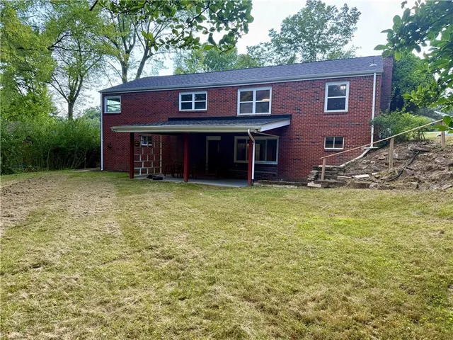 a view of a house with backyard porch and garden