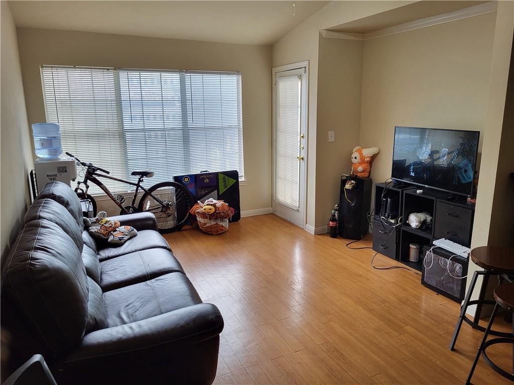 501 West 26th Street, Unit 316 Austin, TX 78705 - Photo 2 of 9 a living room with furniture and a flat screen tv