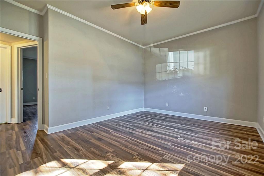 5925 Quail Hollow Road, Unit F Charlotte, NC 28210 - Photo 12 of 14 a view of a livingroom with a chandelier fan and wooden floor