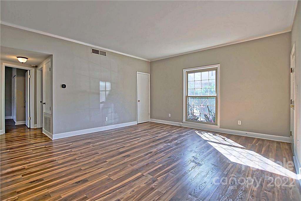 5925 Quail Hollow Road, Unit F Charlotte, NC 28210 - Photo 4 of 14 a view of empty room with wooden floor and fan