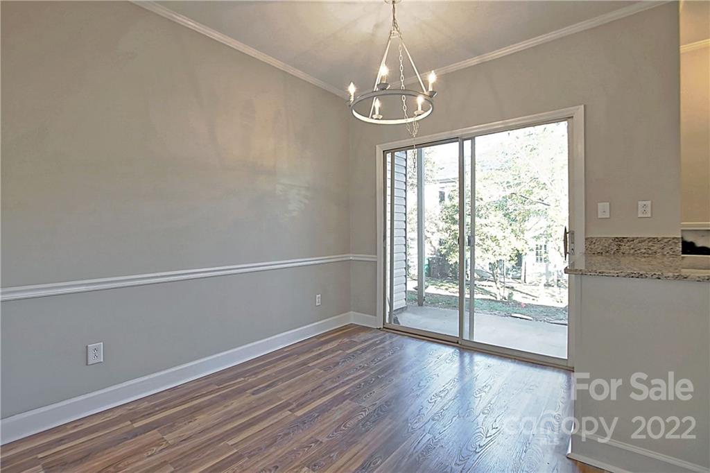 5925 Quail Hollow Road, Unit F Charlotte, NC 28210 - Photo 7 of 14 a view of empty room with wooden floor and fan