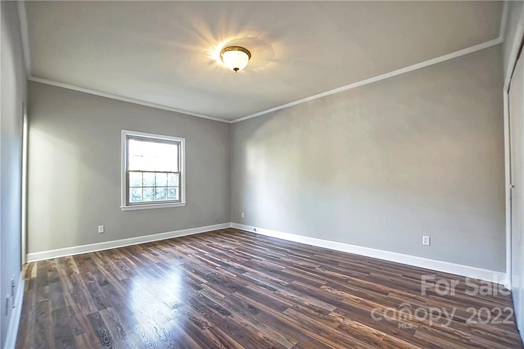 5925 Quail Hollow Road, Unit F Charlotte, NC 28210 - Photo 8 of 14 wooden floor in an empty room with a window