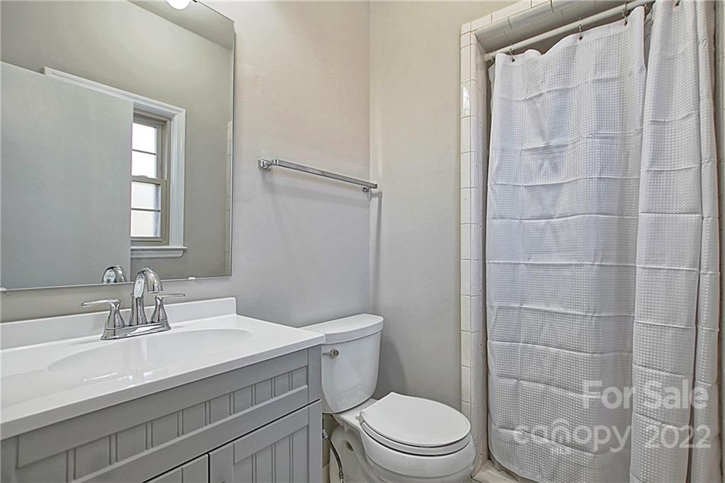5925 Quail Hollow Road, Unit F Charlotte, NC 28210 - Photo 10 of 14 a bathroom with a sink a toilet and shower