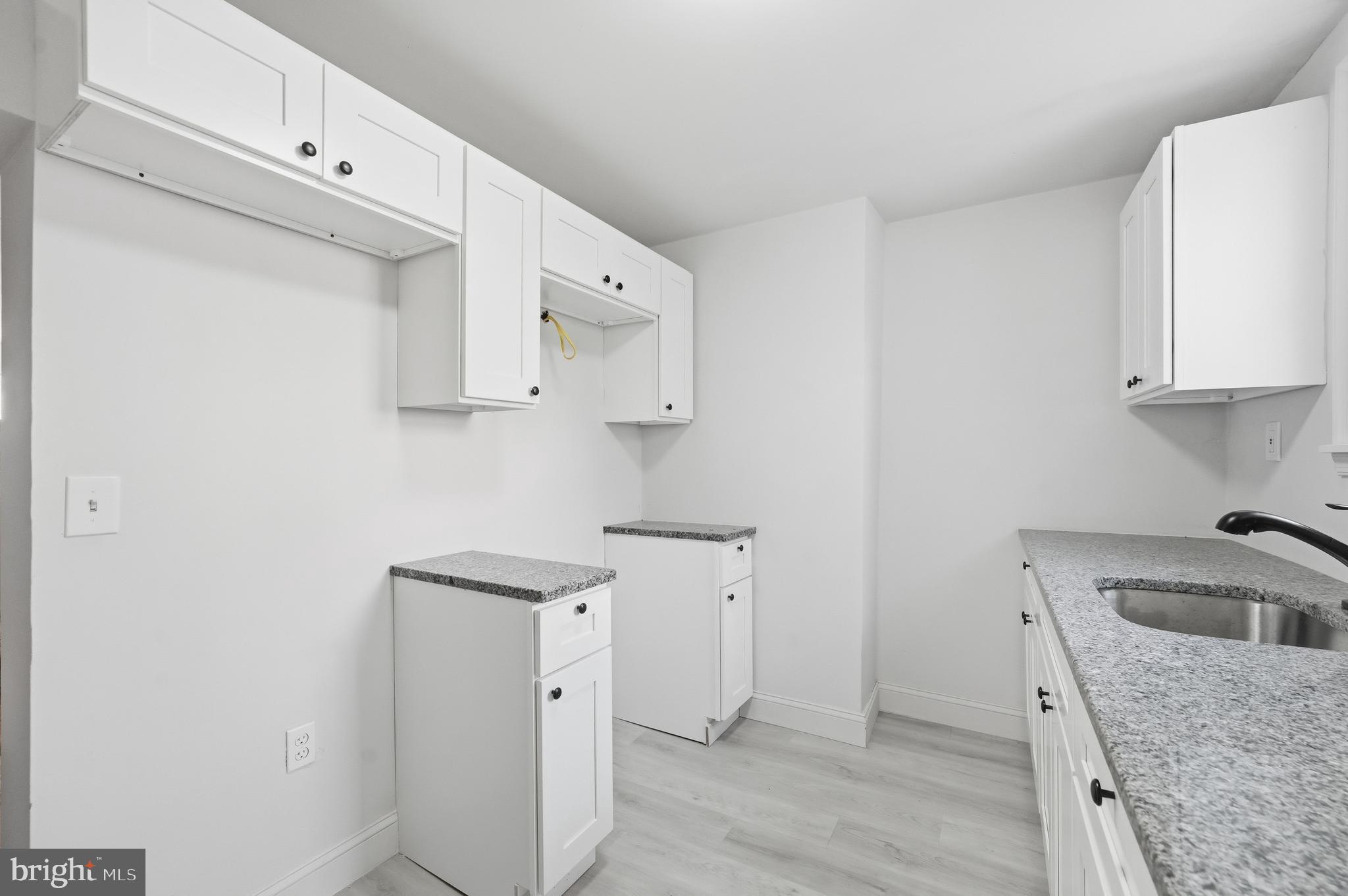 2333 East Huntingdon Street Philadelphia, PA 19125 - Photo 14 of 26 a kitchen with cabinets and wooden floor