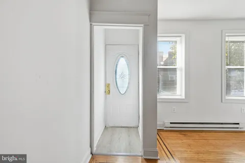 a view of a room with wooden floor and window