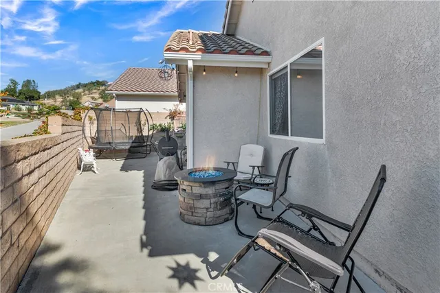 a view of a patio with table and chairs and potted plants