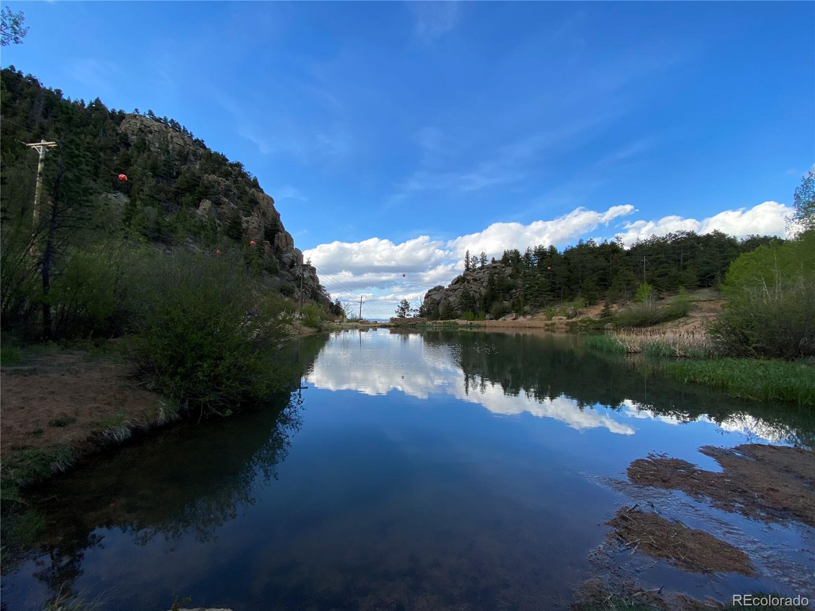 116 Happy Valley Road Manitou Springs, CO 80829 - Photo 23 of 25 a view of a lake in middle of forest