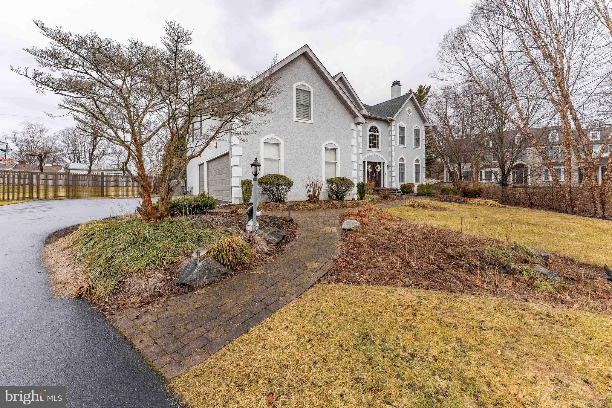 300 Bell Court Exton, PA 19341 - Photo 7 of 79 a view of a white house with a yard covered in snow