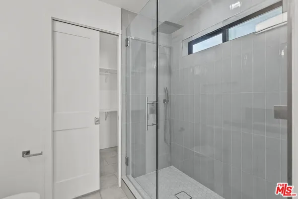 a bathroom with a glass shower door