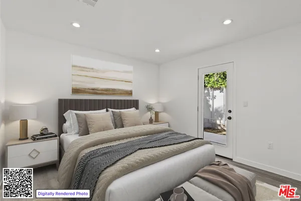 a bedroom with a bed and a night stand