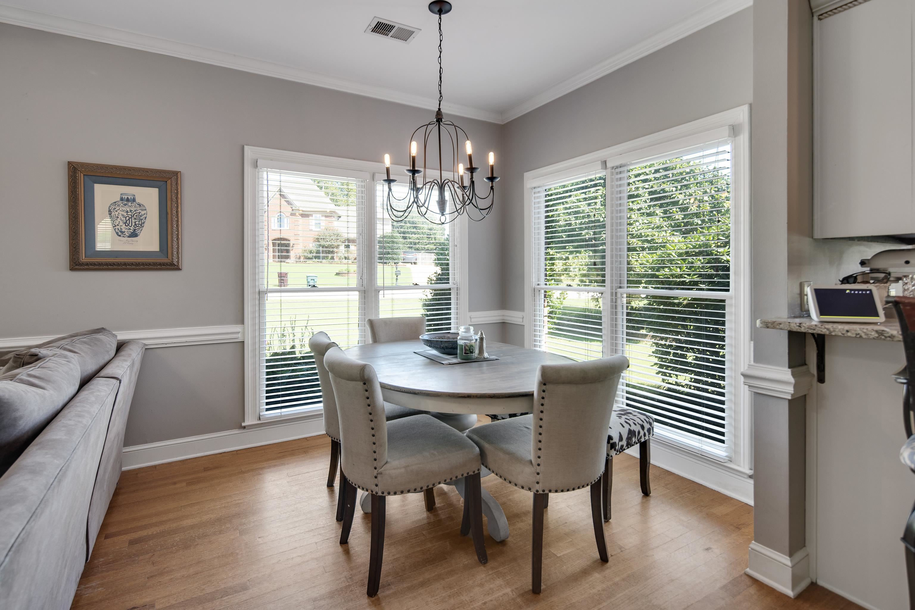 1323 Colbert Cove Collierville, TN 38017 - Photo 20 of 40 Dining space with light wood-type flooring, ornamental molding, and an inviting chandelier