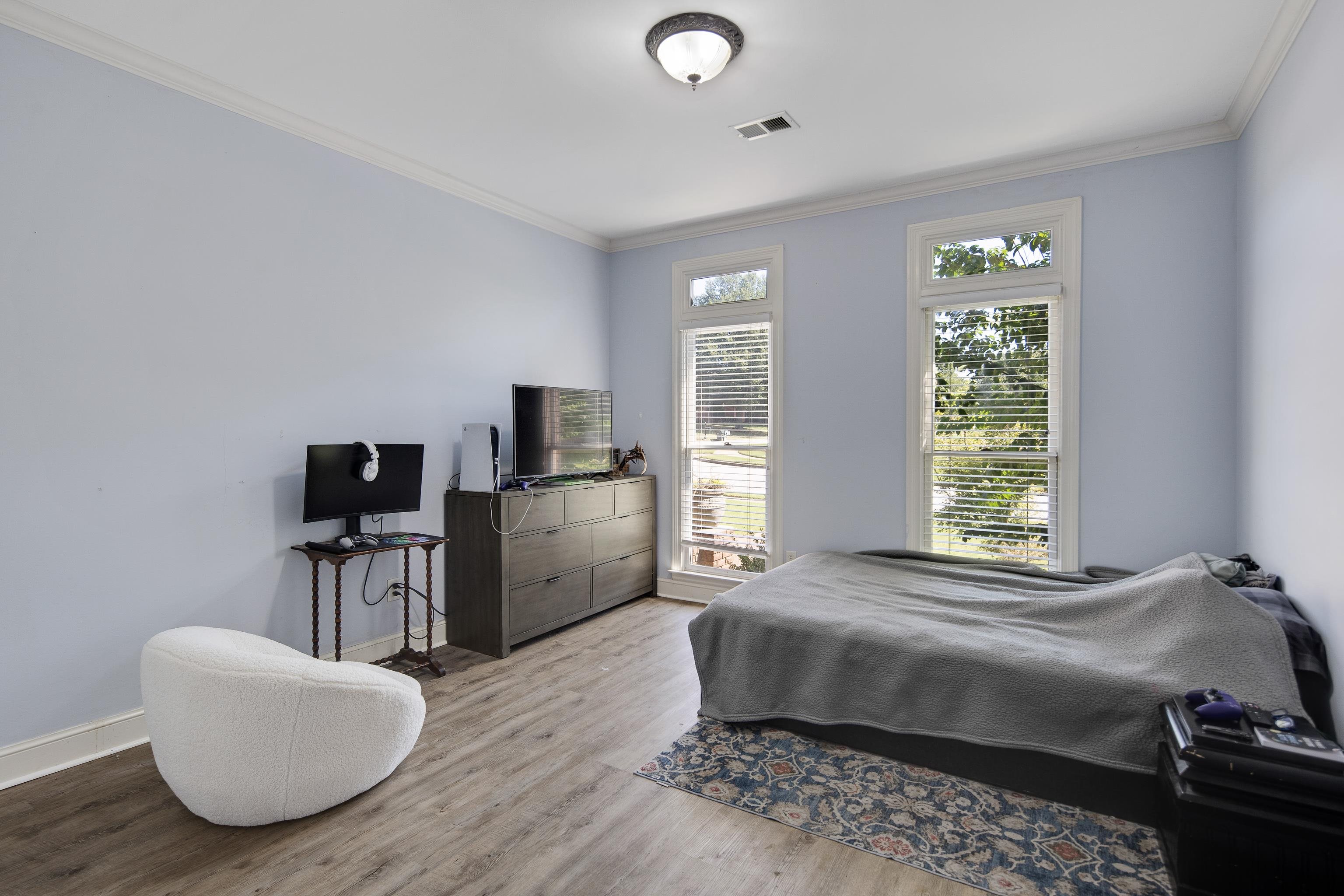 1323 Colbert Cove Collierville, TN 38017 - Photo 25 of 40 Bedroom featuring light wood-type flooring and crown molding