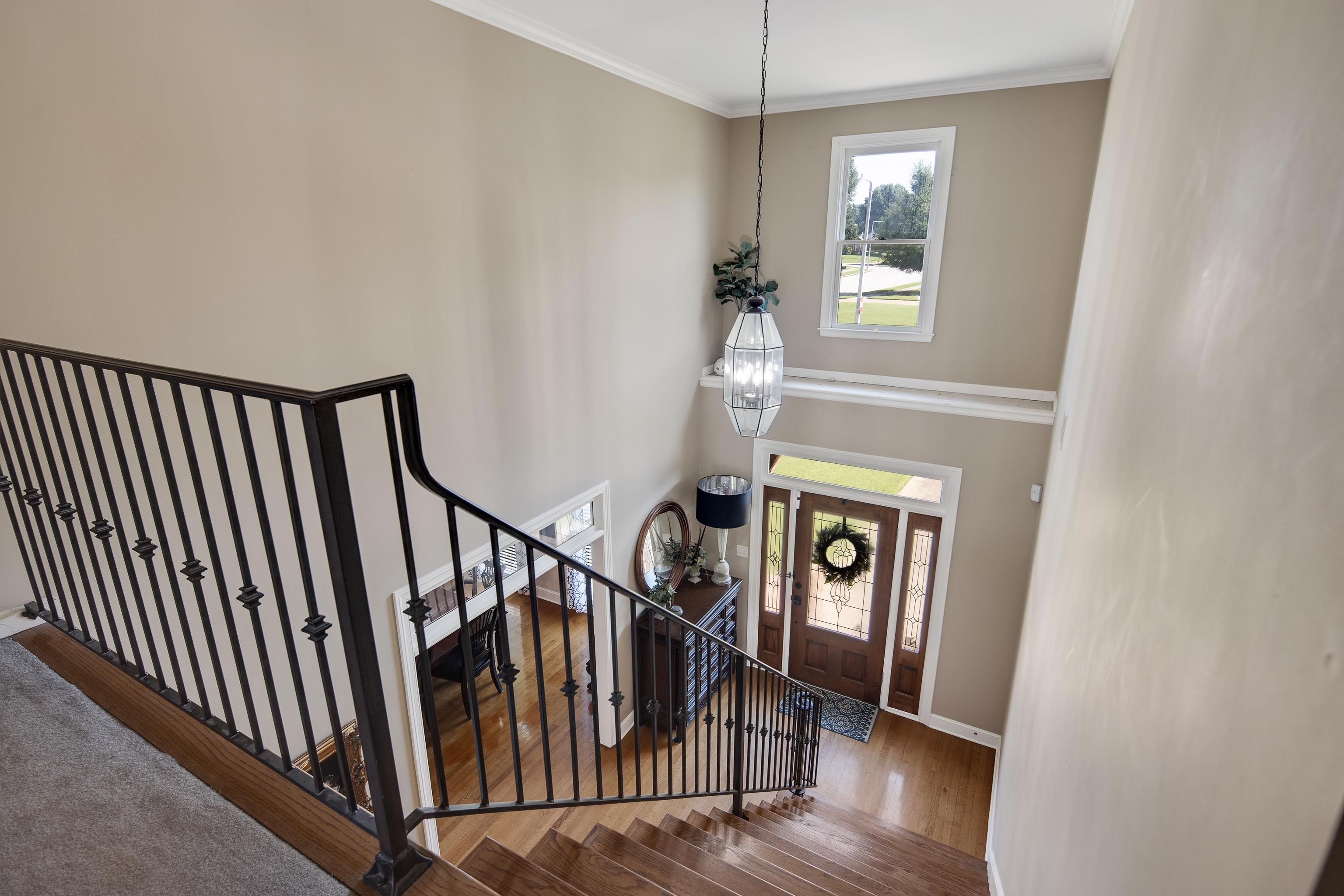 1323 Colbert Cove Collierville, TN 38017 - Photo 28 of 40 Entryway featuring crown molding, hardwood / wood-style floors, and a chandelier