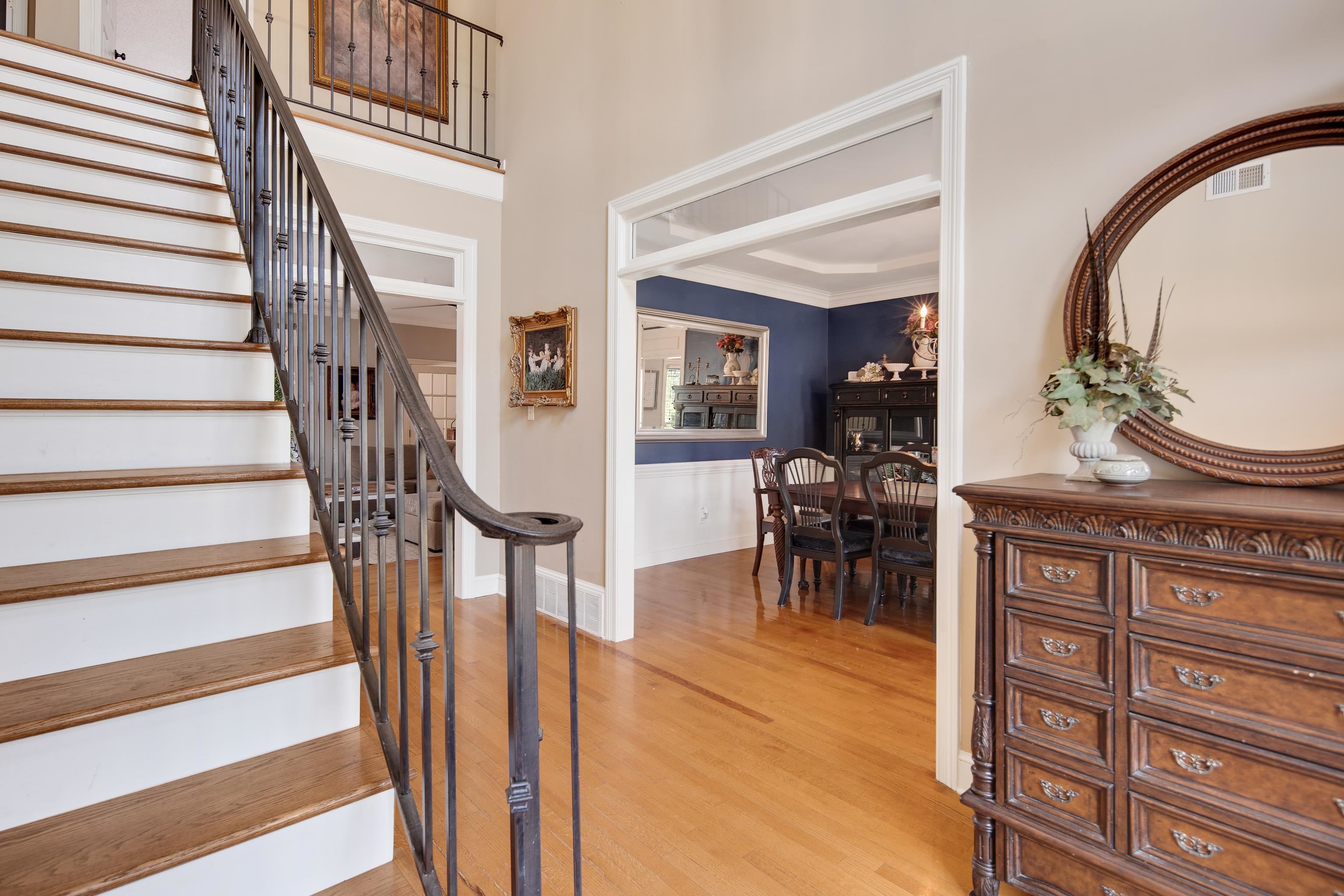 1323 Colbert Cove Collierville, TN 38017 - Photo 8 of 40 Stairs featuring hardwood / wood-style floors and a notable chandelier