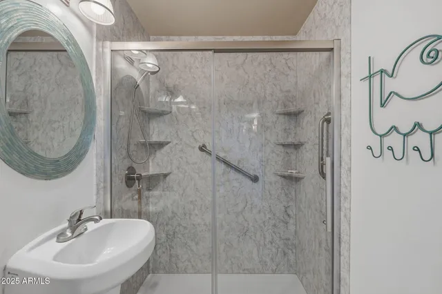 a bathroom with a sink a mirror and a shower