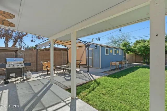 a view of a patio with table and chairs and potted plants