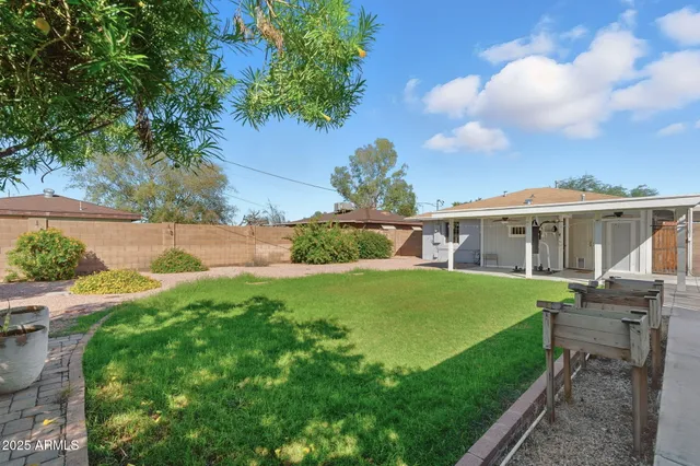 a view of backyard of house with green space