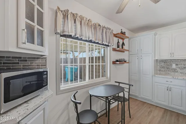 a view of a kitchen with furniture and wooden floor