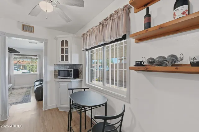 a balcony with table and chairs