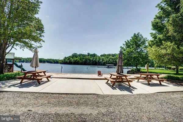 a view of a swimming pool with chairs and a fire pit