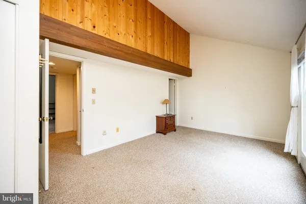 a view of a livingroom with wooden floor and a ceiling fan