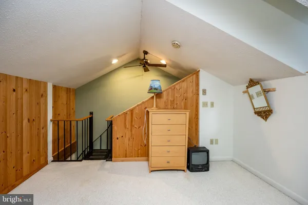 a living room with stairs and a wooden floor