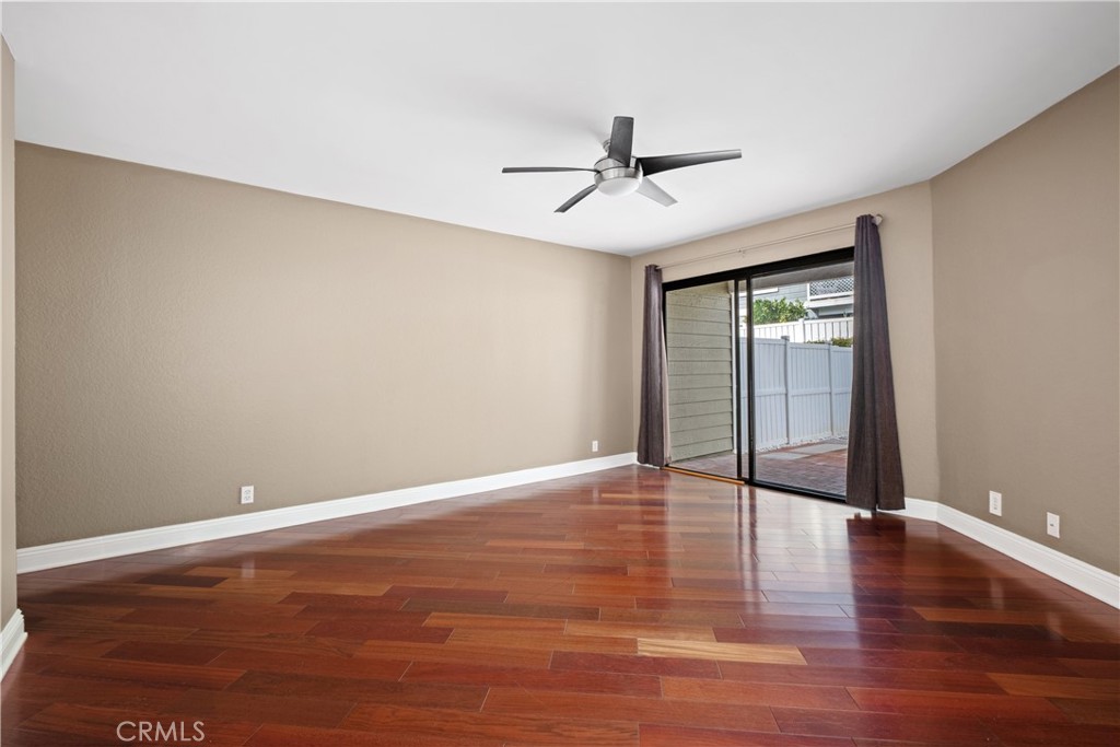 7 Oak Spring Lane, Unit 319 Aliso Viejo, CA 92656 - Photo 13 of 37 a view of an empty room with wooden floor and a ceiling fan