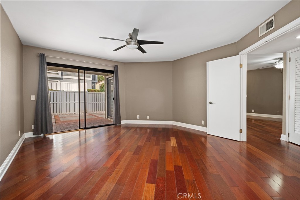 7 Oak Spring Lane, Unit 319 Aliso Viejo, CA 92656 - Photo 14 of 37 an empty room with wooden floor and windows