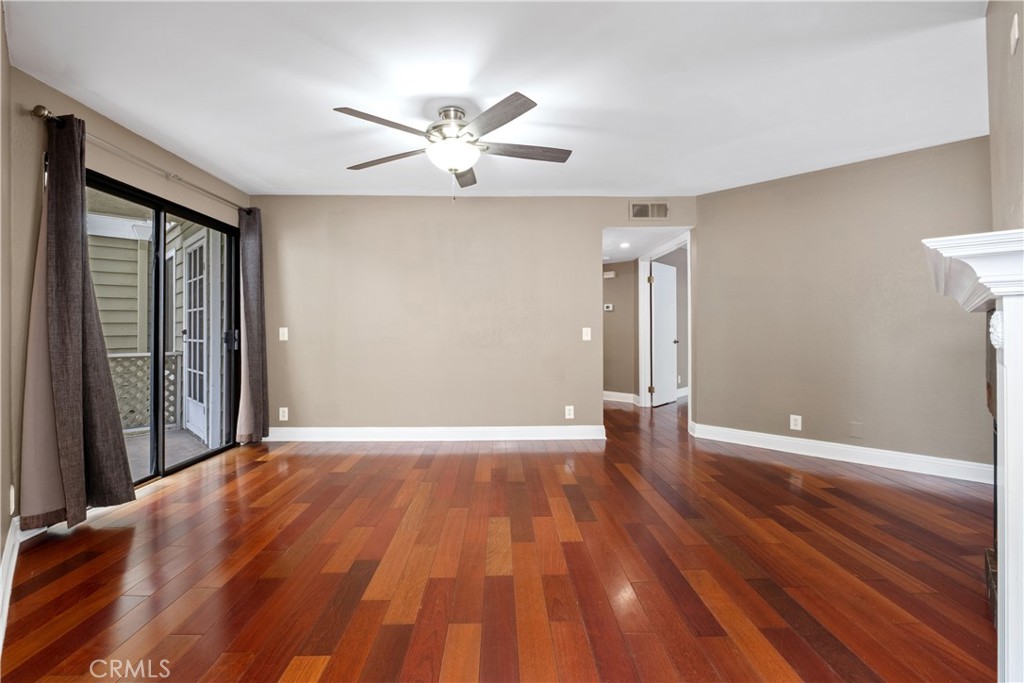 7 Oak Spring Lane, Unit 319 Aliso Viejo, CA 92656 - Photo 2 of 37 a view of an empty room with wooden floor and a window