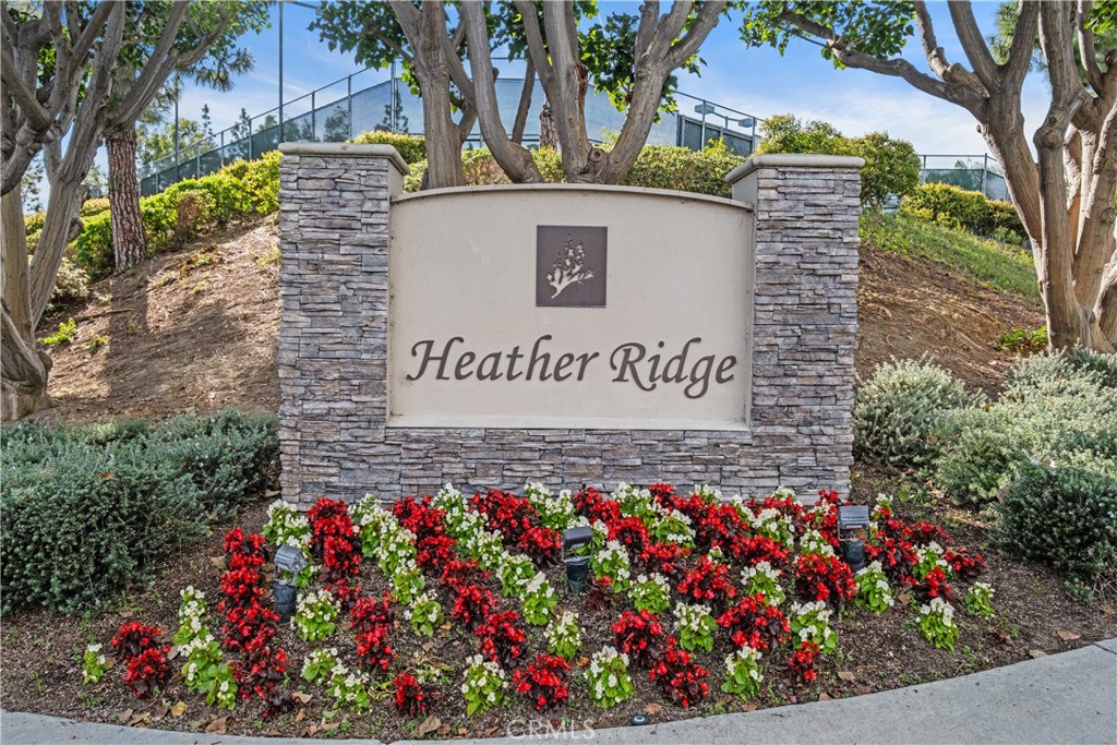 7 Oak Spring Lane, Unit 319 Aliso Viejo, CA 92656 - Photo 26 of 37 a sign that is in front of flowers