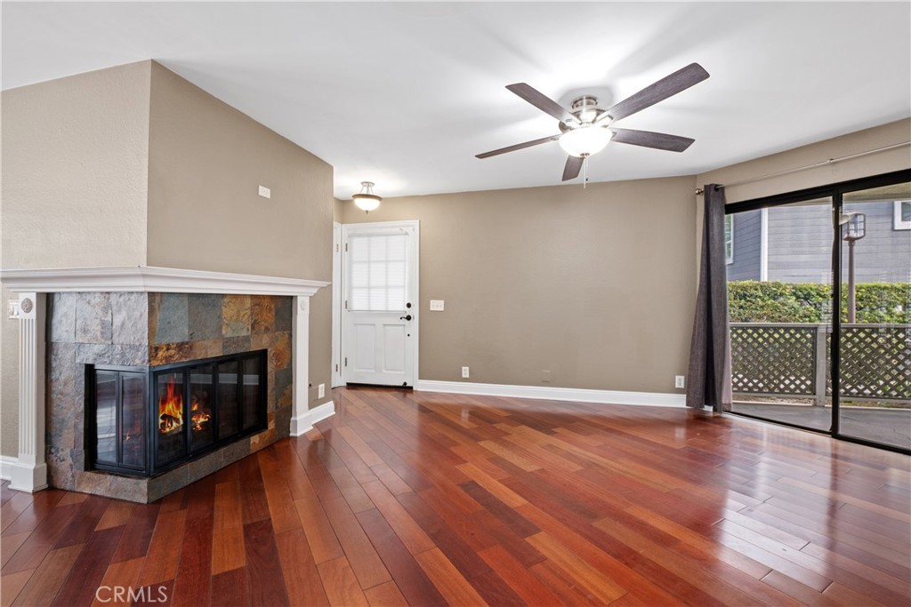 7 Oak Spring Lane, Unit 319 Aliso Viejo, CA 92656 - Photo 3 of 37 a view of an empty room with wooden floor fireplace and a window